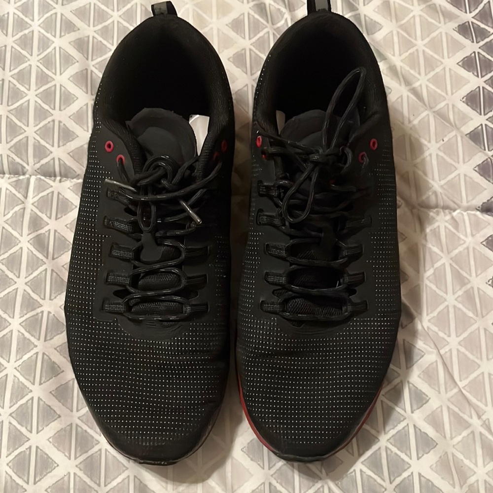 A pair of black and red Air Jordan sneakers size 11.5